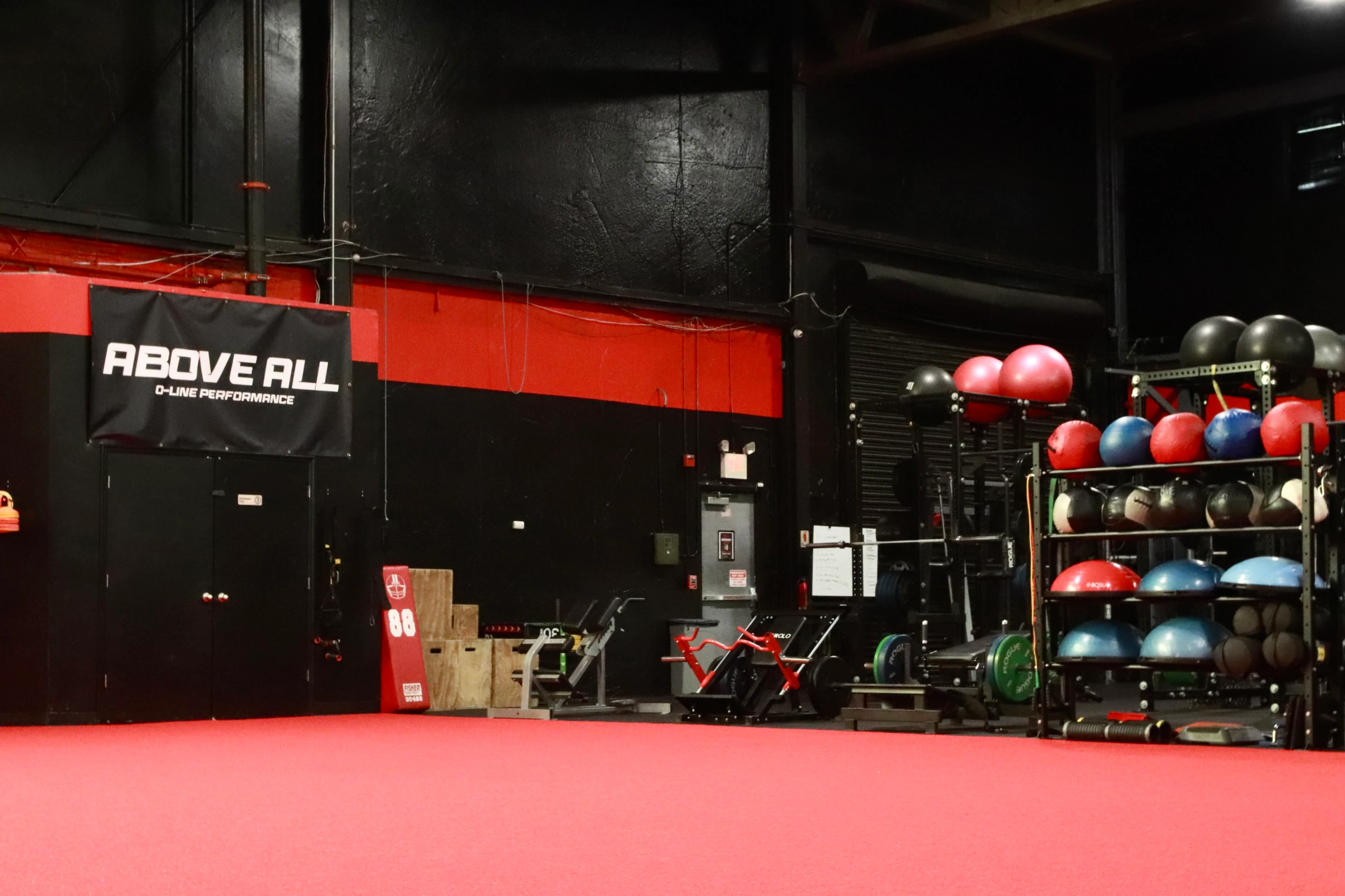 Sports performance turf with plyo boxes, sleds and a medicine ball rack at XCEL in Fairfield, NJ