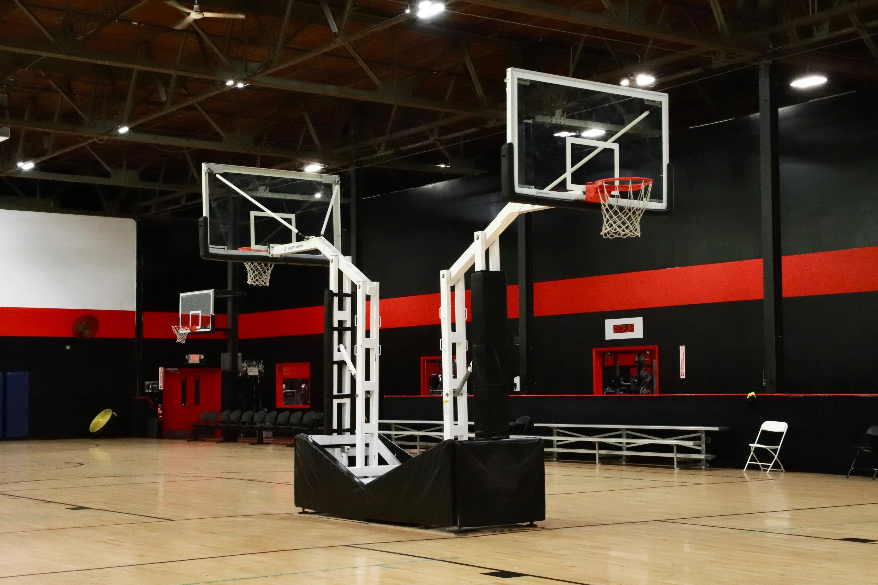 Two regulation indoor basketball courts with glass backboards at XCEL Sports & Fitness in Fairfield, NJ